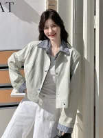 Woman smiling in a stylish women's jacket outdoors